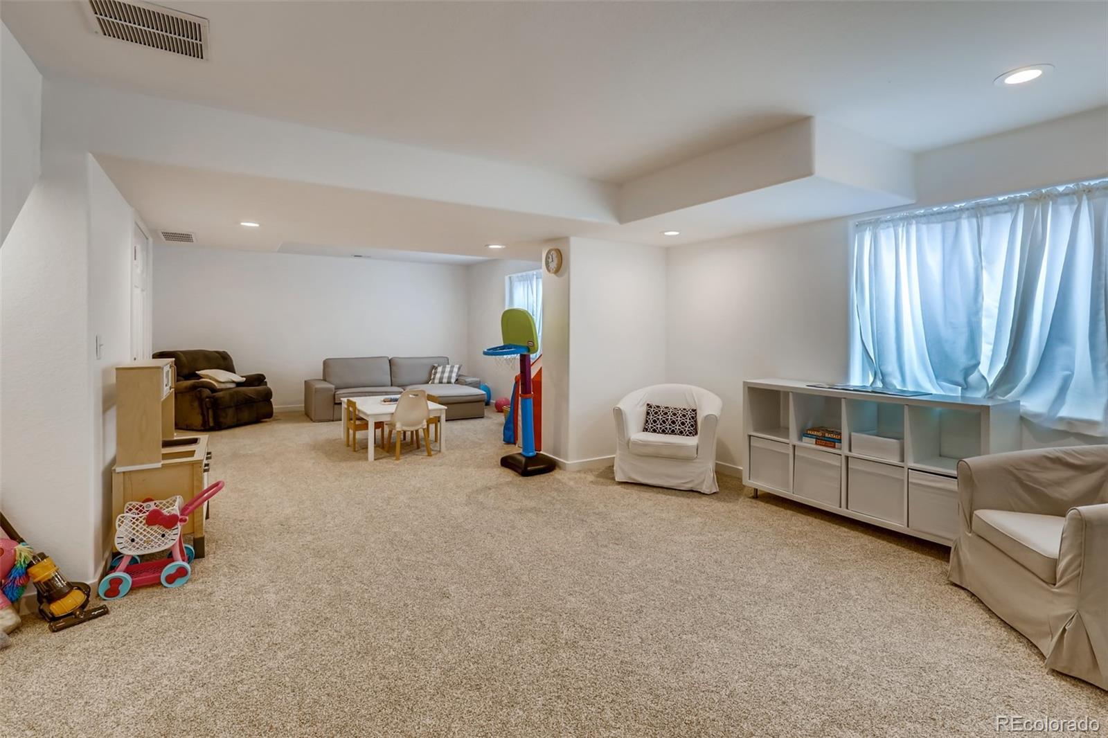 8537 Raspberry Drive Frederick, CO 80504 - Photo 20 of 31 a living room with furniture and a flat screen tv