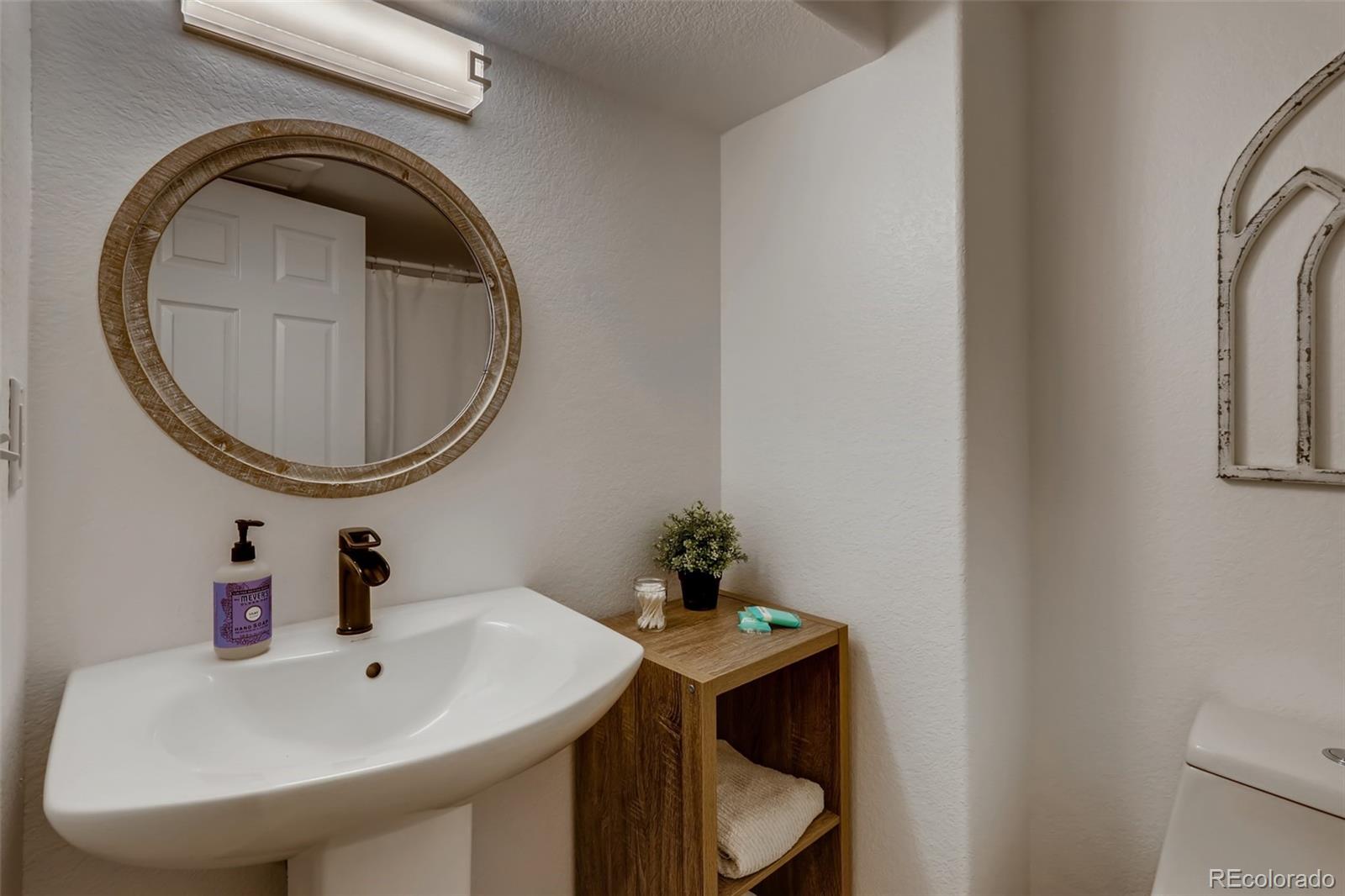 8537 Raspberry Drive Frederick, CO 80504 - Photo 24 of 31 a bathroom with a sink and a mirror