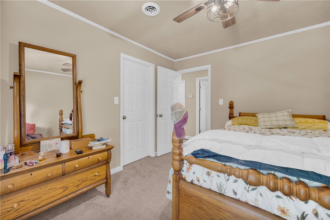 3030 Smith McGee Road Iva, SC 29655 - Photo 30 of 46 A well-lit bedroom featuring soft carpeting and a wooden bed frame with a dresser and mirror.