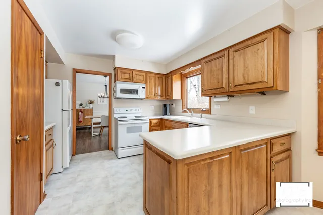 a kitchen with a stove a sink and a refrigerator