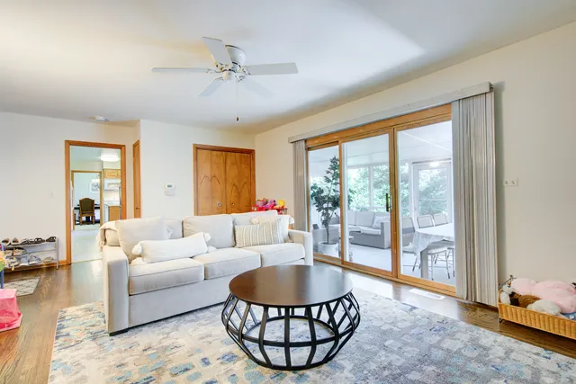 a living room with furniture a table and a large window