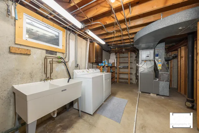 a utility room with cabinets dryer and washer