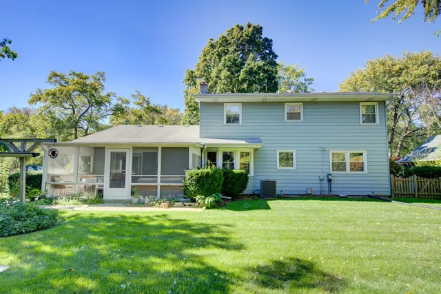 a view of a house with a yard and potted plants