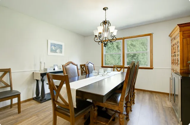 a view of a dining room with furniture wooden floor and chandelier