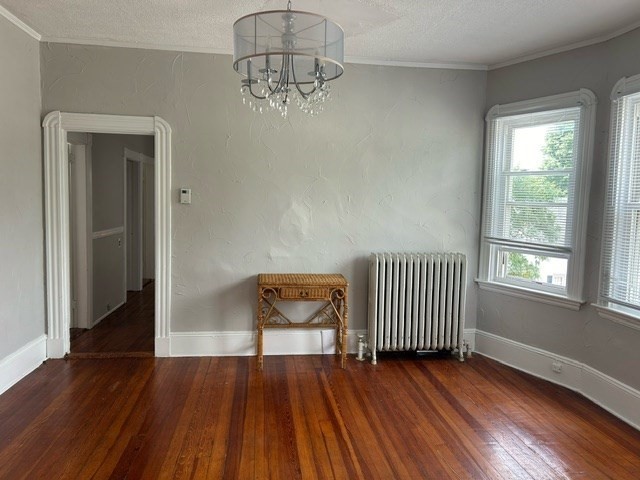 516 Union Street, Unit 2 New Bedford, MA 02740 - Photo 3 of 11 an empty room with wooden floor door and windows