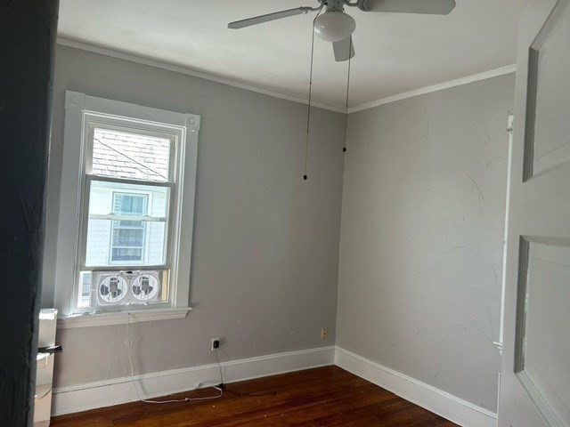 516 Union Street, Unit 2 New Bedford, MA 02740 - Photo 5 of 11 a view of an empty room with wooden floor and a window