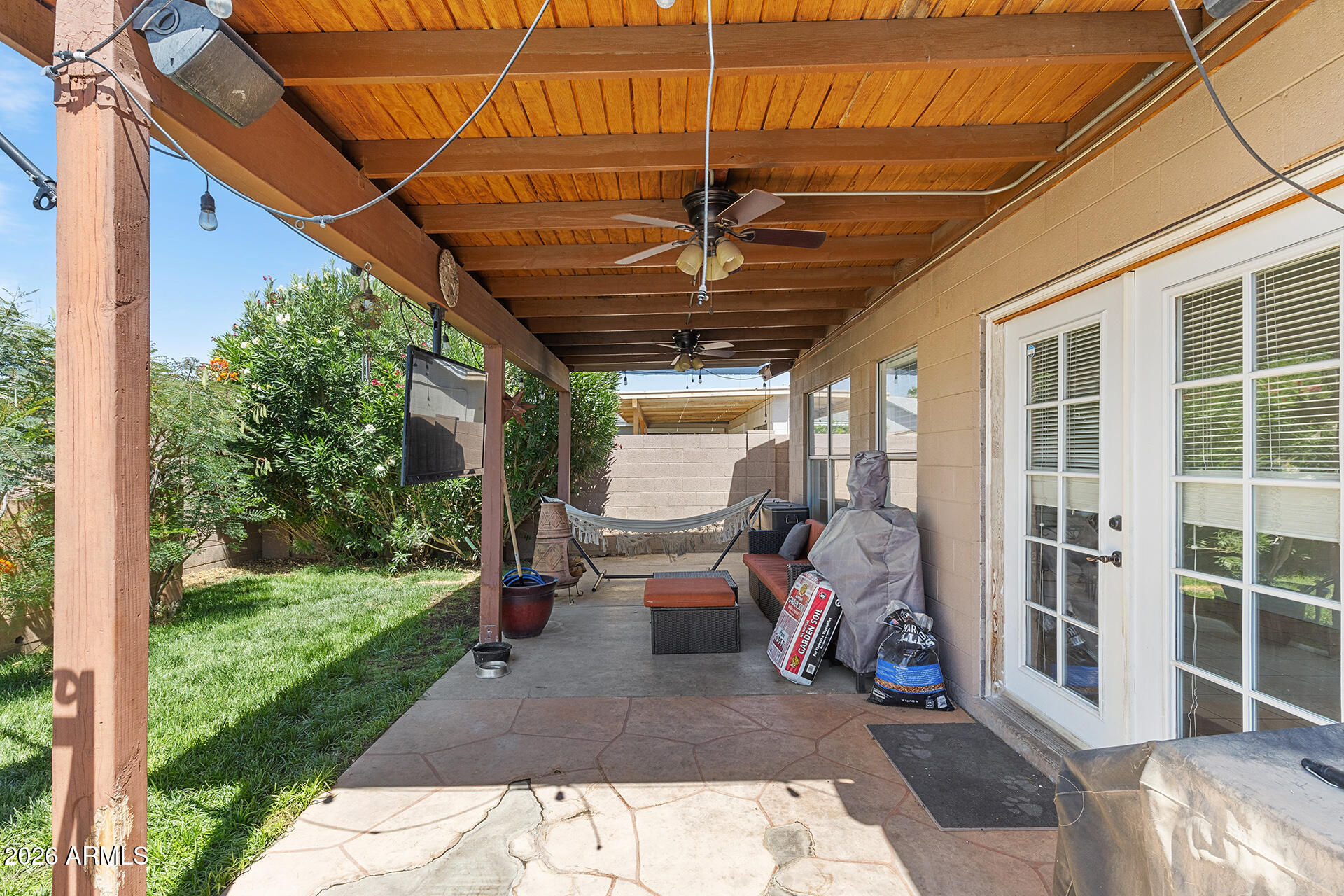 9002 West Coronado Road Phoenix, AZ 85037 - Photo 46 of 54 a view of a patio with table and chairs under an umbrella