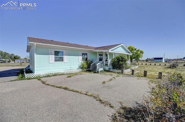 11955 Smith Road Peyton, CO 80831 - Photo 8 of 24 Ranch-style house featuring a porch