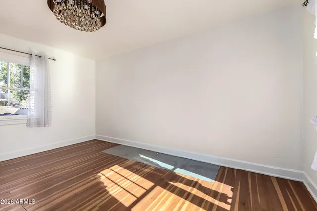 a view of wooden floor and windows in a room