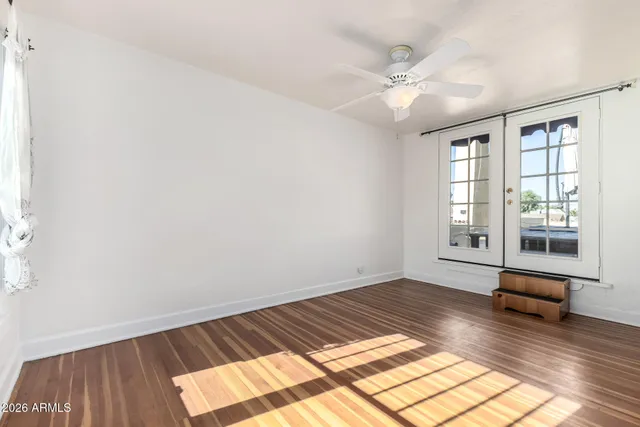 wooden floor in an empty room with a window