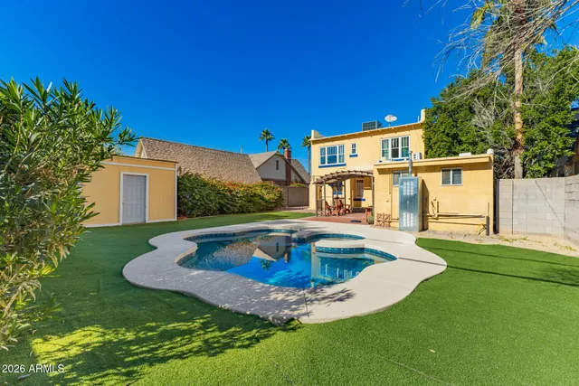 a view of a house with swimming pool and a yard