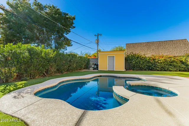 a view of a swimming pool with a yard