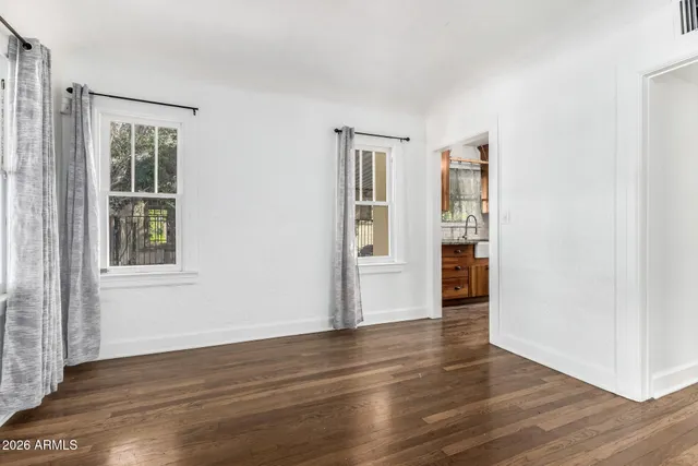 a view of wooden floor and windows in a room
