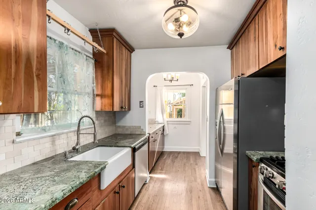a kitchen with a refrigerator and a sink