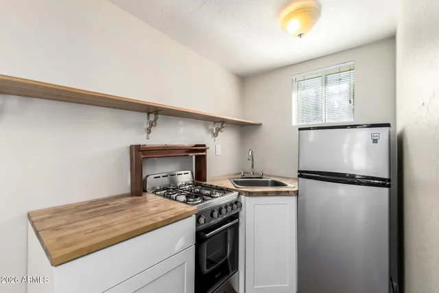 a kitchen with a stove and a refrigerator