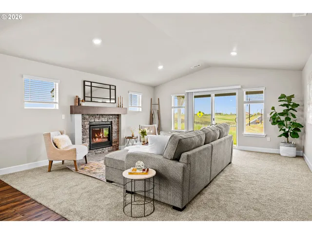 a living room with furniture a fireplace and a potted plant