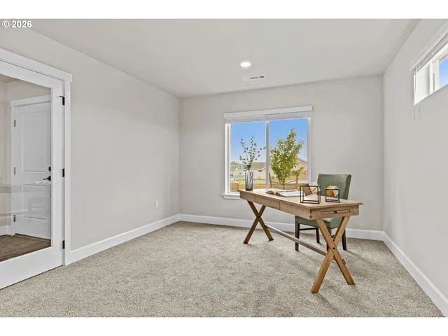 a workspace room with furniture and a window