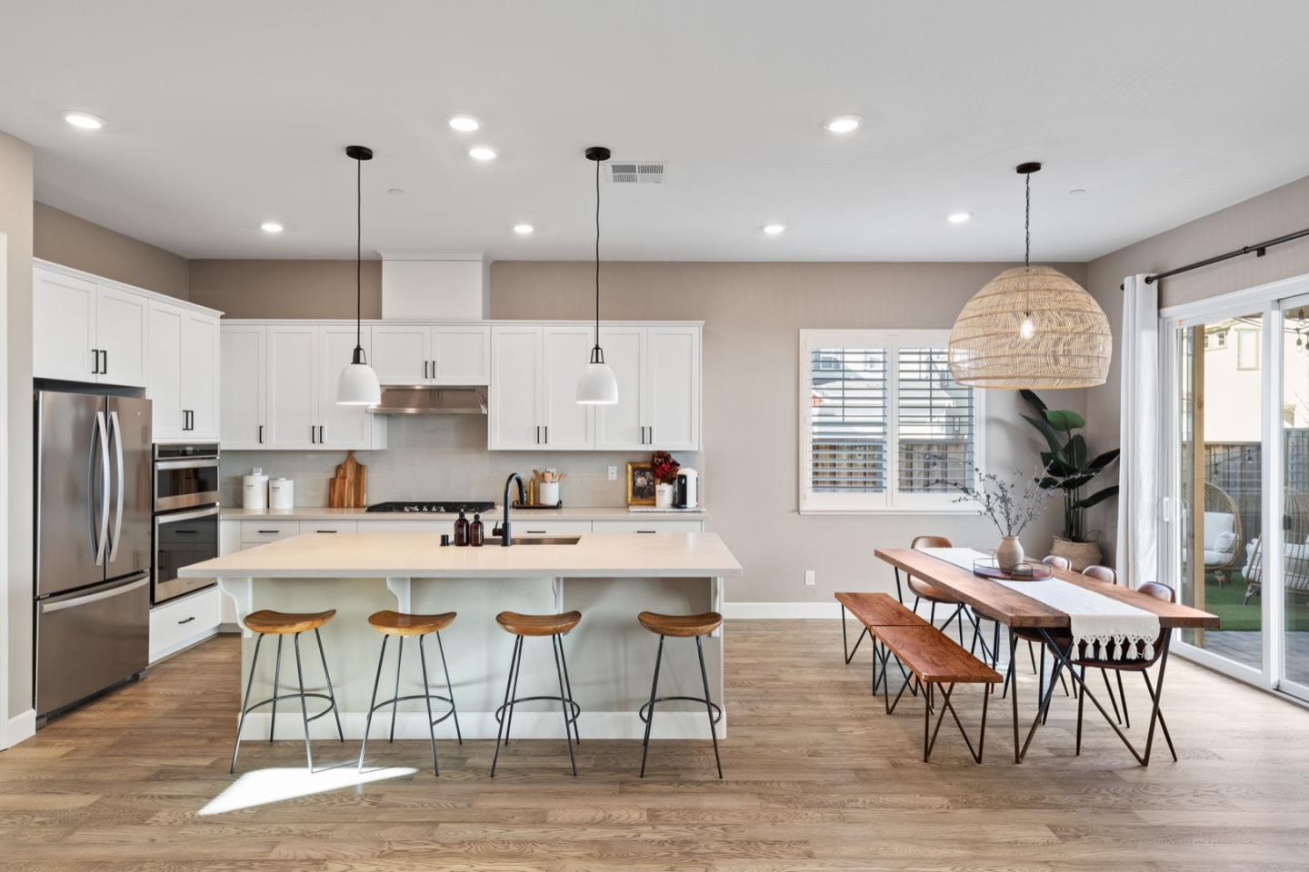 39941 Seal Drive Newark, CA 94560 - Photo 6 of 28 a kitchen with stainless steel appliances granite countertop a stove a refrigerator a kitchen island a dining table and chairs