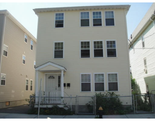 79 Burrell Street Boston, MA 02119 - Photo 1 of 1 a view of a brick building next to a yard