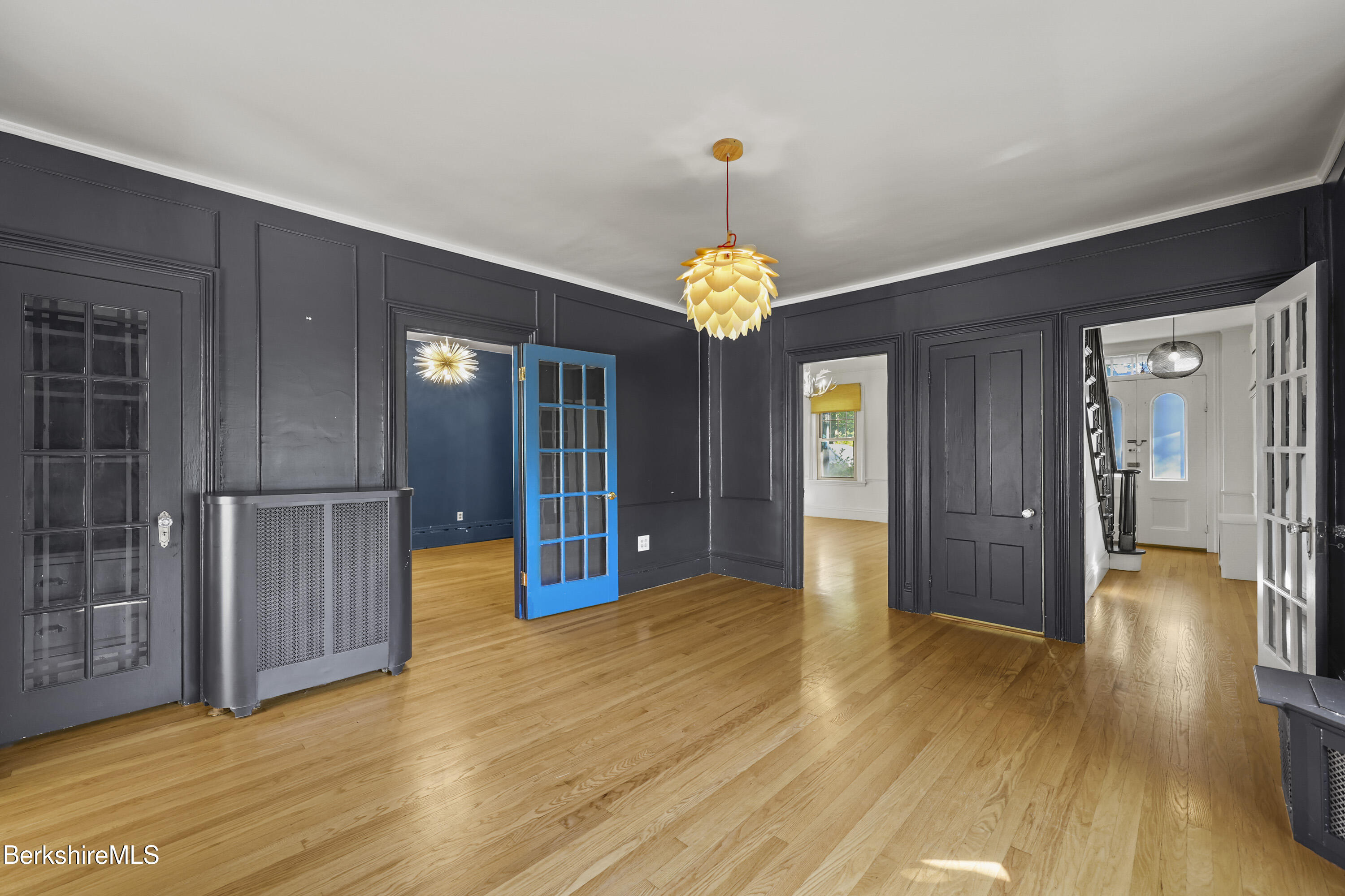 22 Maple Street Adams, MA 01220 - Photo 13 of 65 a view of an empty room with wooden floor and a kitchen