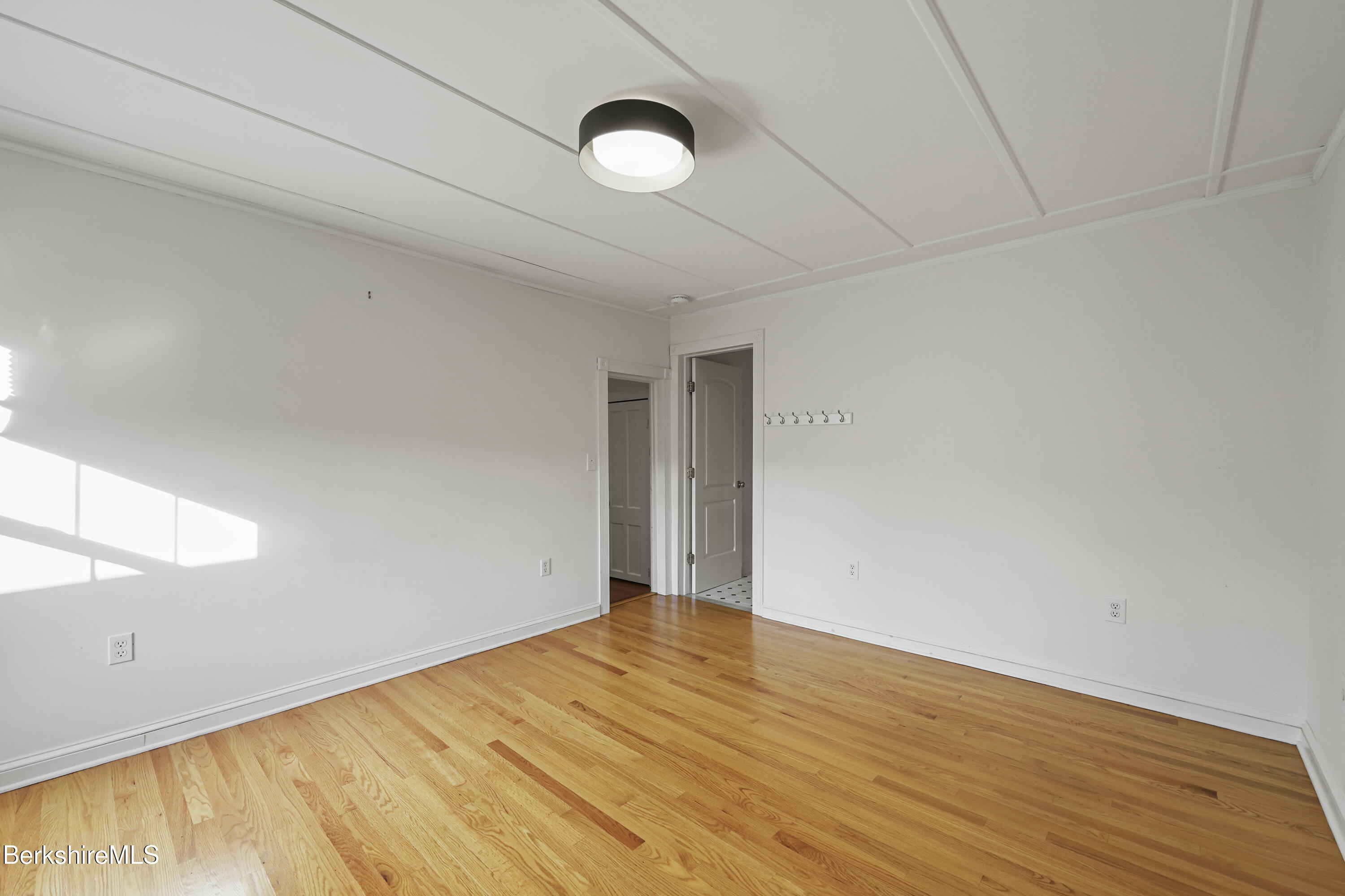 22 Maple Street Adams, MA 01220 - Photo 39 of 65 a view of an empty room with wooden floor and a window