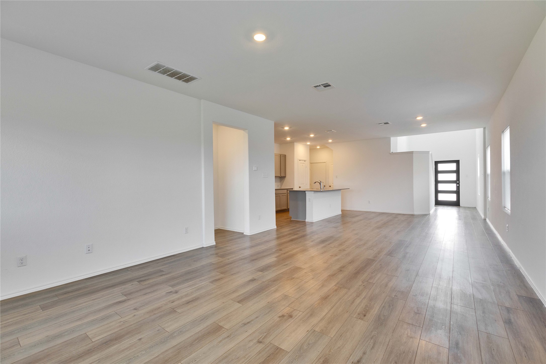 206 Canley Loop Hutto, TX 78634 - Photo 6 of 31 a view of an empty room and a kitchen