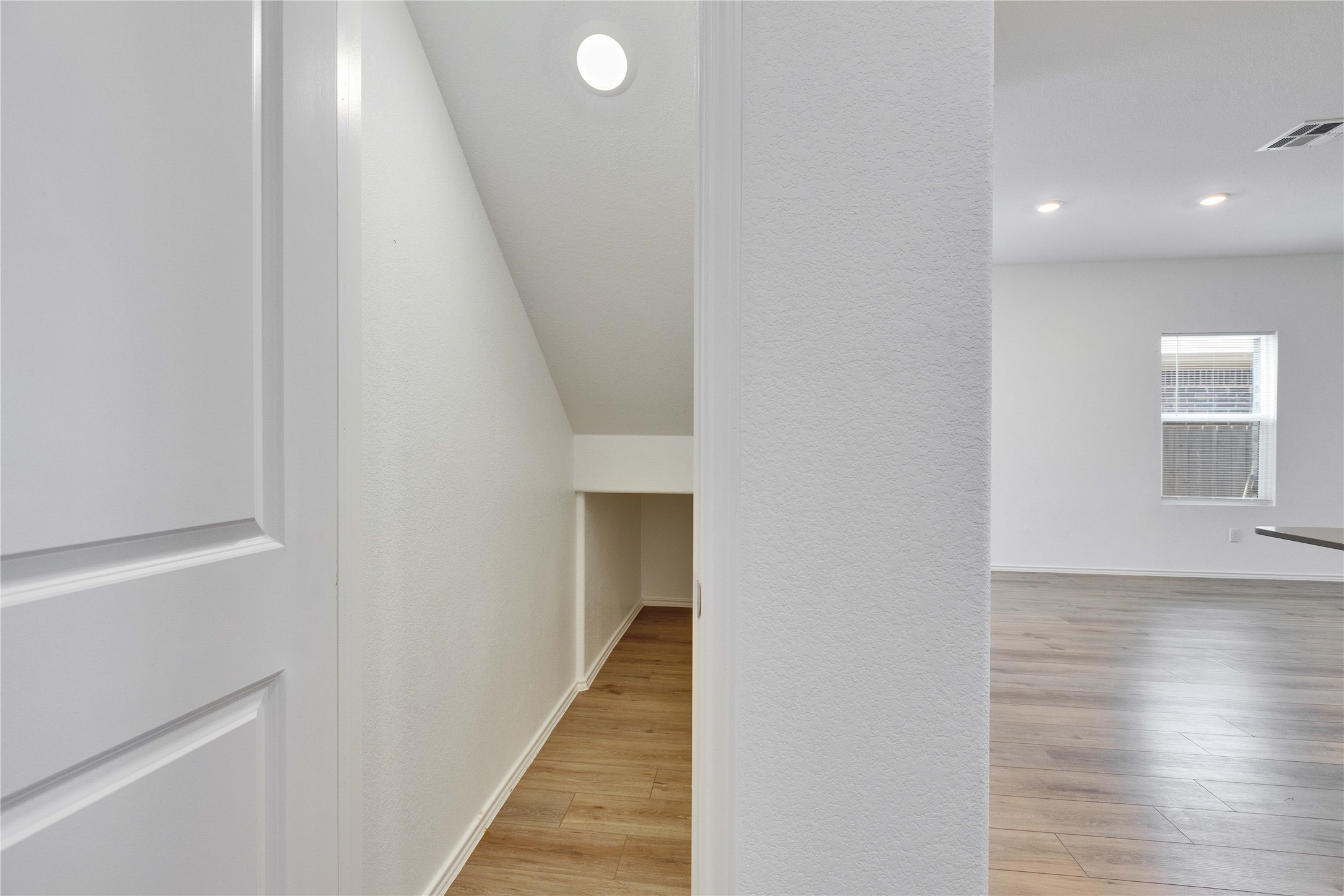 206 Canley Loop Hutto, TX 78634 - Photo 9 of 31 a view of a hallway with wooden floor and staircase