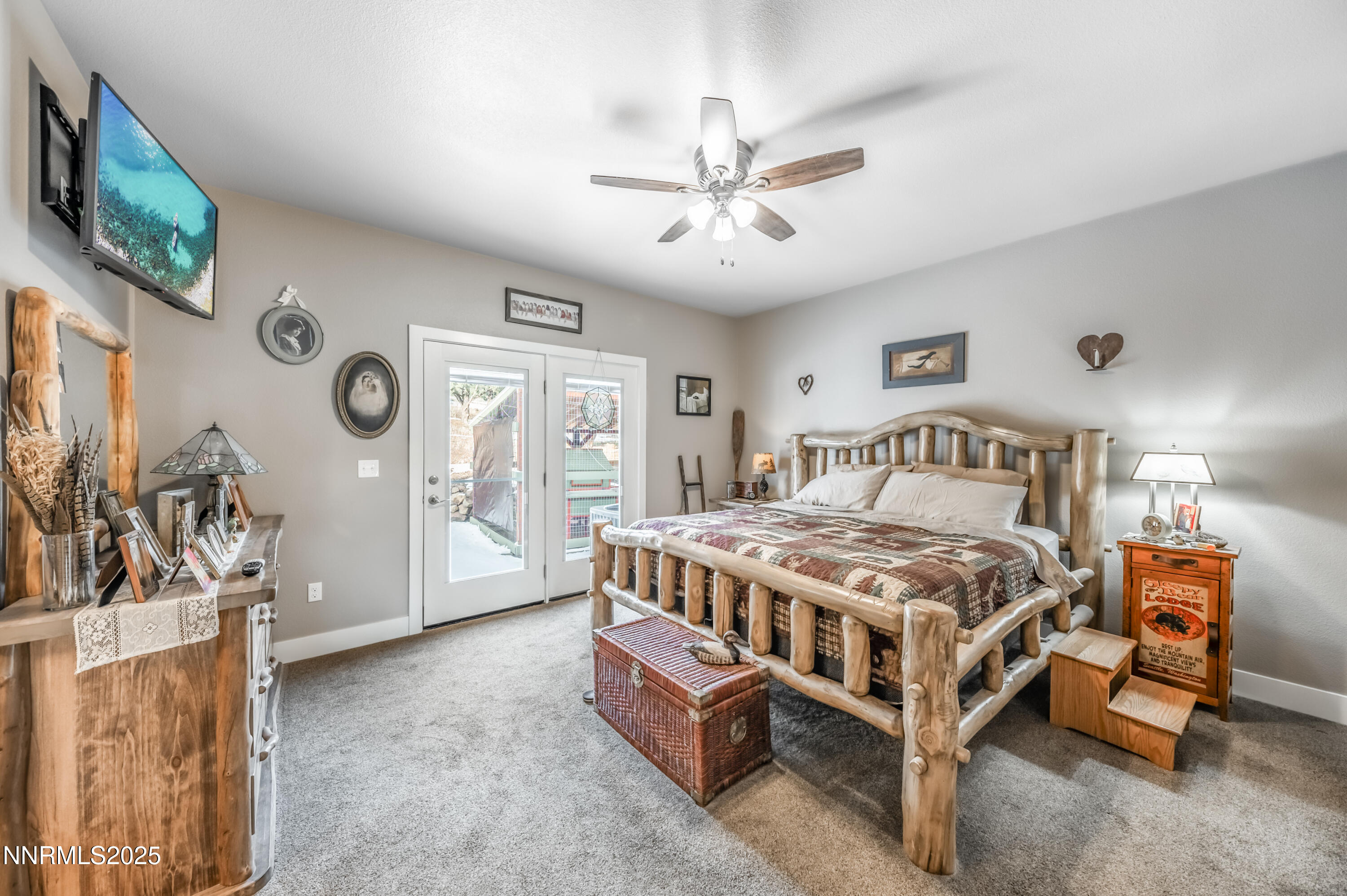 2486 Cartwright Road Reno, NV 89521 - Photo 14 of 44 a bedroom with a bed a flat screen tv and a chandelier