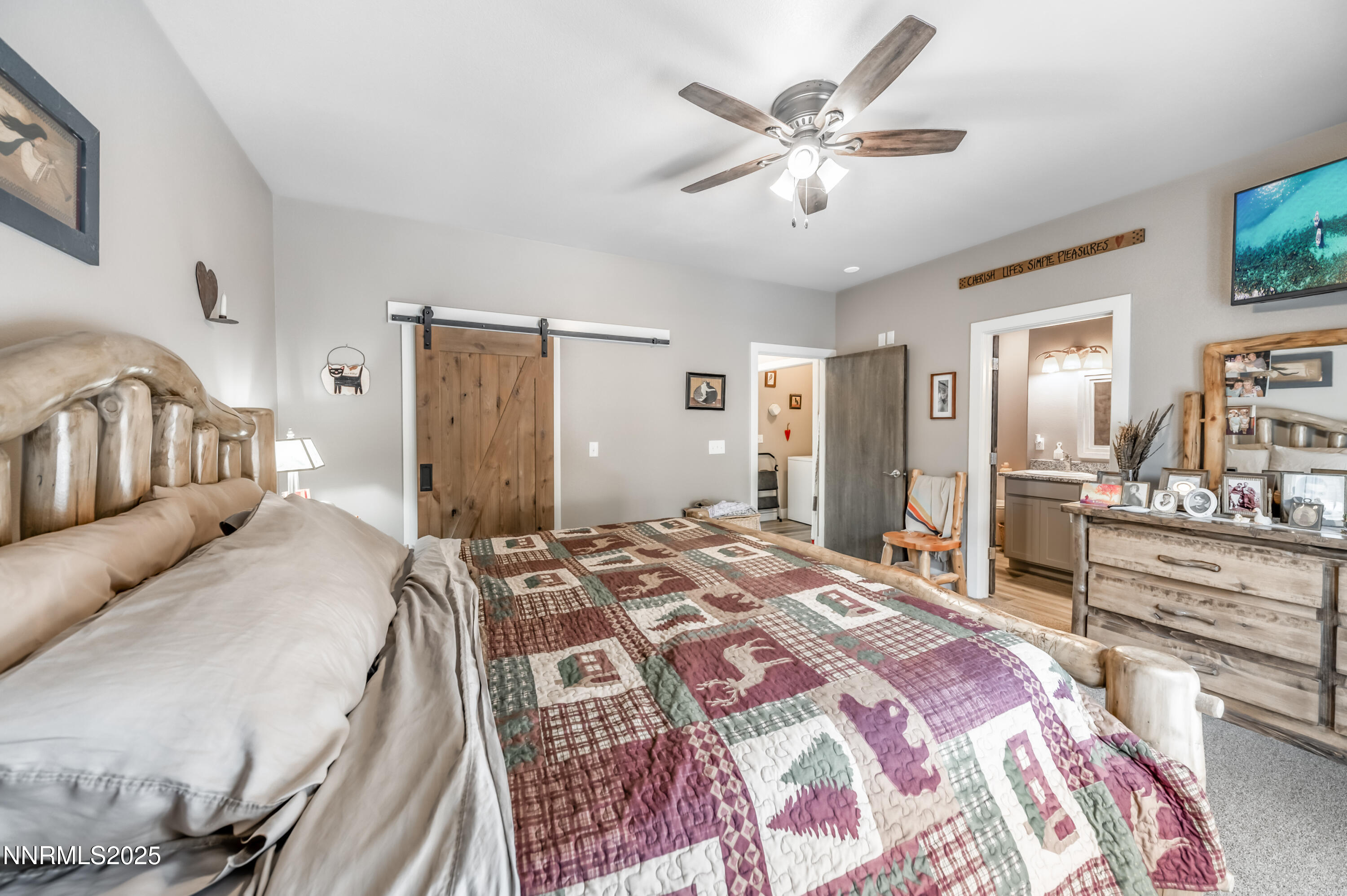 2486 Cartwright Road Reno, NV 89521 - Photo 15 of 44 a bedroom with a large bed and a chandelier