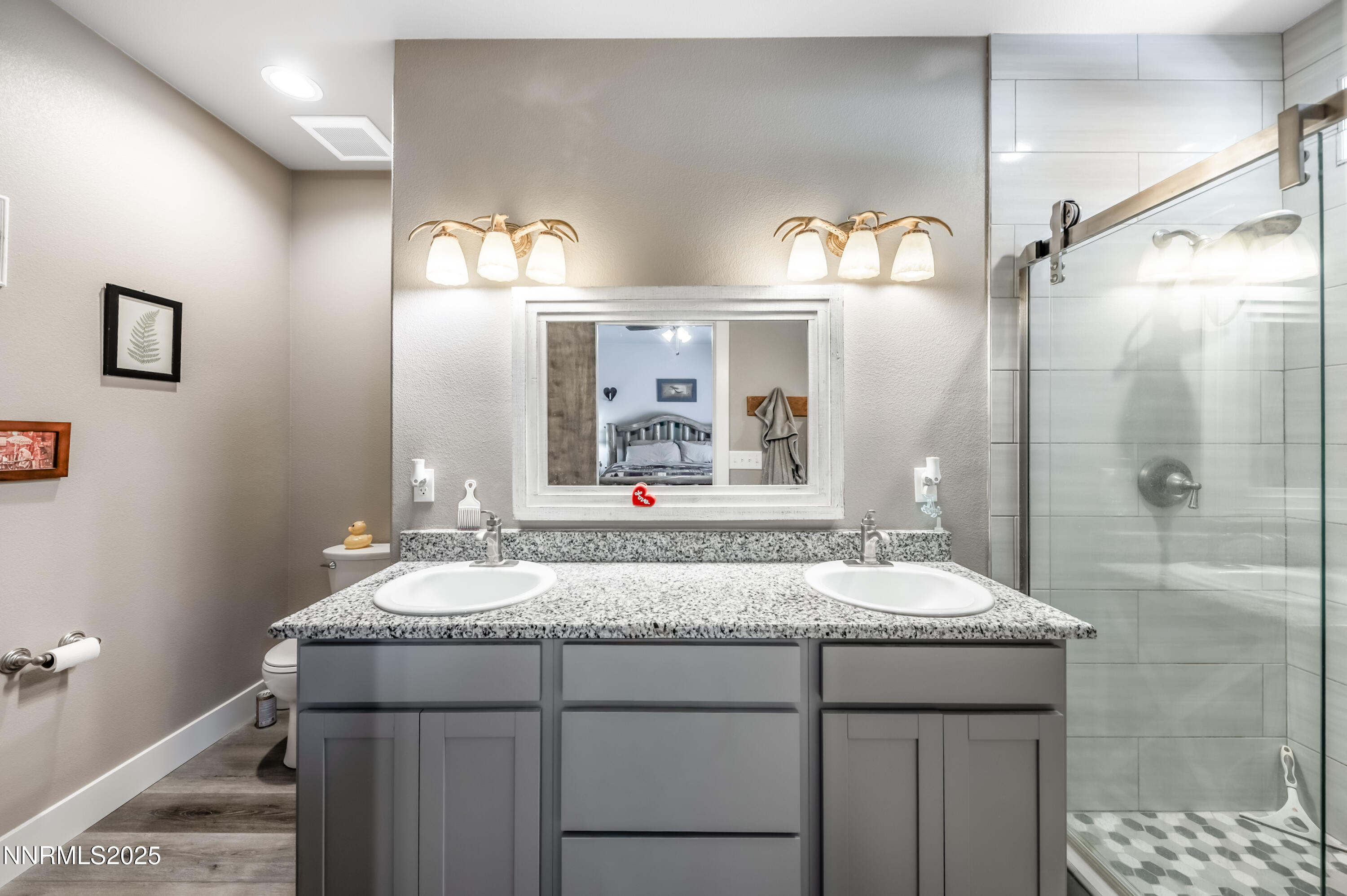 2486 Cartwright Road Reno, NV 89521 - Photo 16 of 44 a bathroom with a granite countertop sink and a mirror