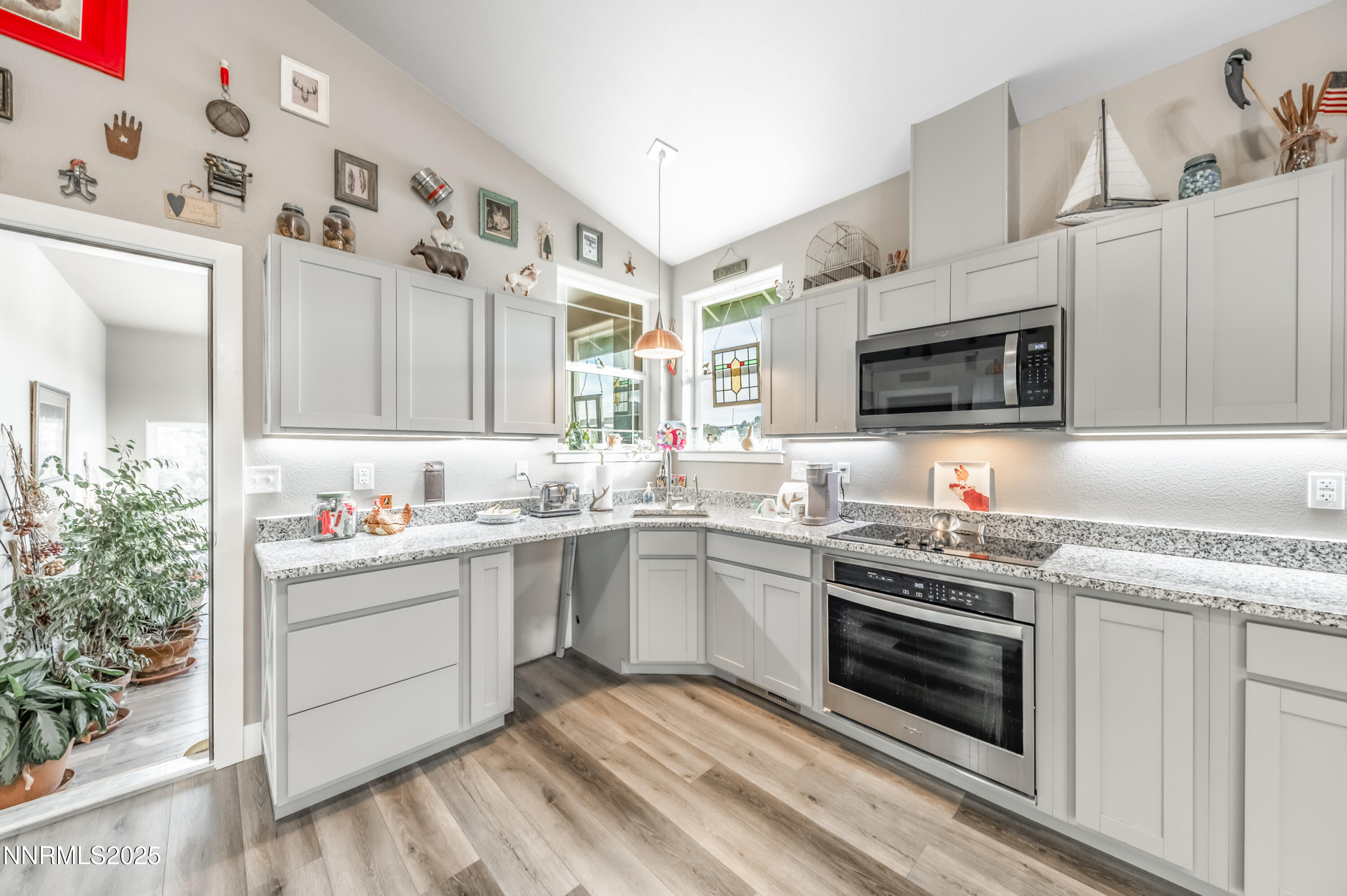 2486 Cartwright Road Reno, NV 89521 - Photo 5 of 44 a kitchen with cabinets stainless steel appliances and wooden floor