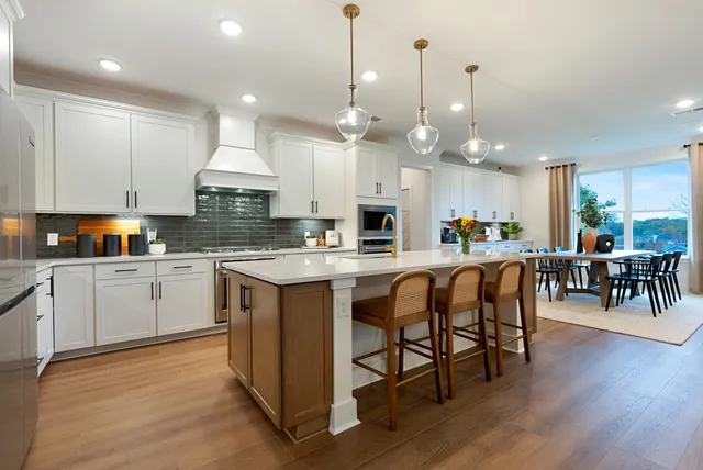 a kitchen with granite countertop white cabinets and refrigerator