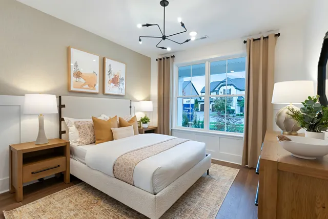 a living room with furniture kitchen view and a chandelier