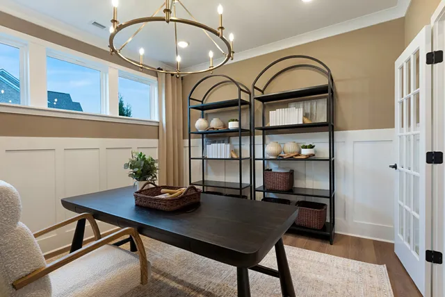 a living room with furniture a window and a flat screen tv