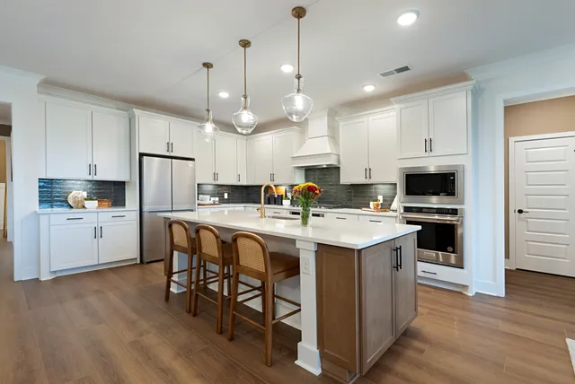 a bathroom with a granite countertop sink toilet and mirror