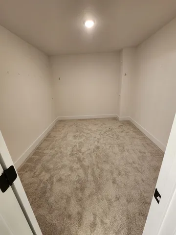 a view of a hallway with wooden floor and windows