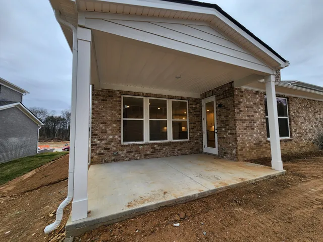 a view of a workspace with furniture and a potted plant