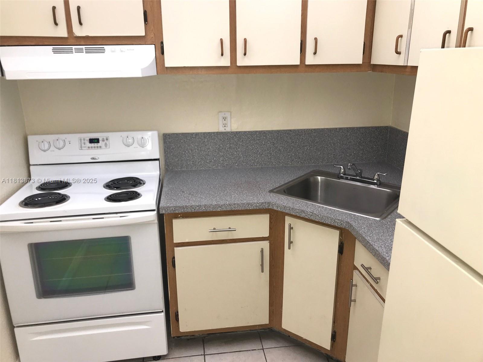 Flagami Miami, FL 33126 - Photo 2 of 9 a kitchen with a stove and a white cabinet