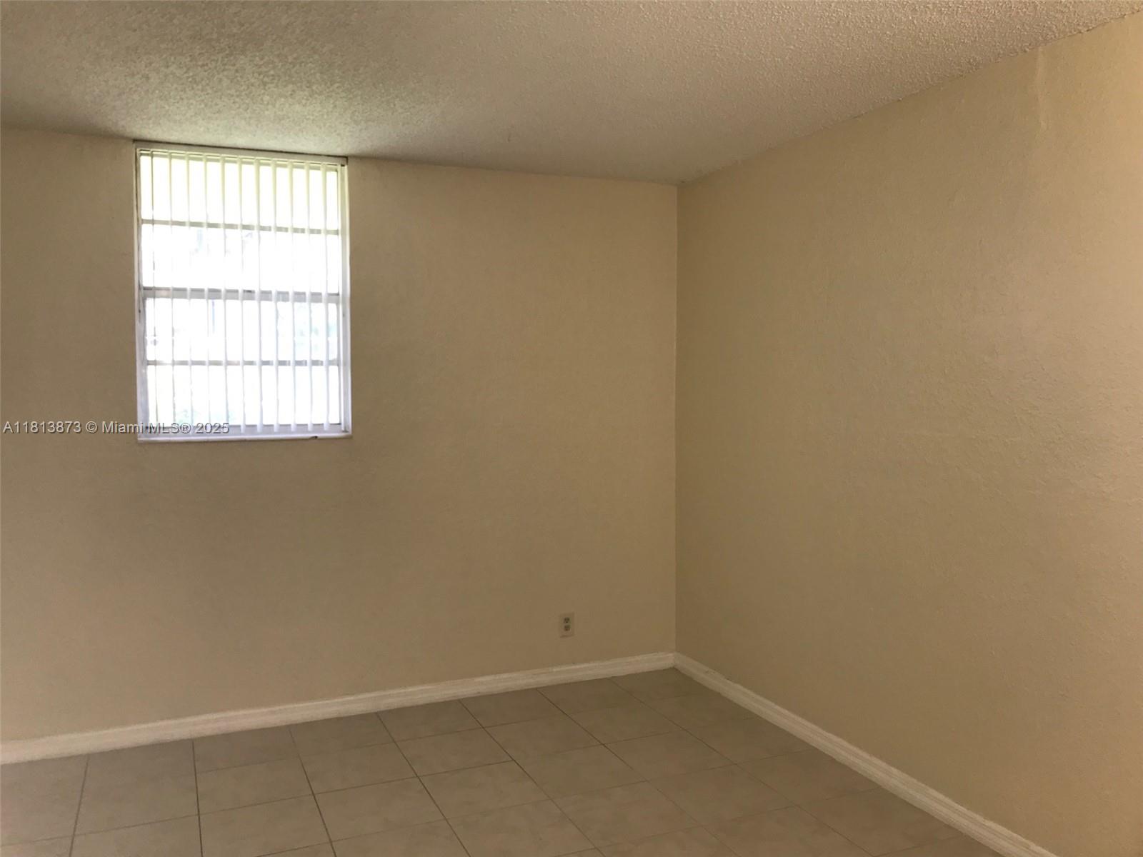 Flagami Miami, FL 33126 - Photo 5 of 9 an empty room with a window