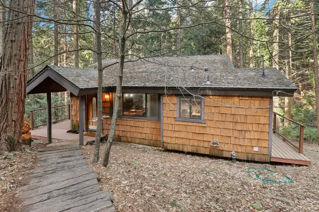 a front view of a house with a wooden bench