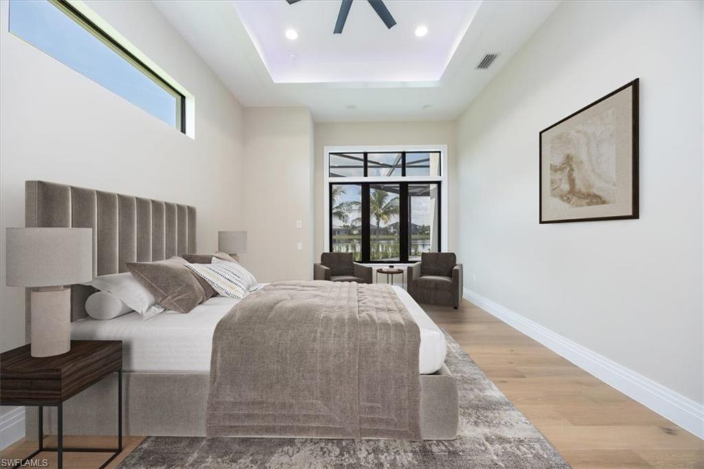 14211 Charthouse Circle Naples, FL 34114 - Photo 23 of 48 Bedroom featuring wood finished floors, a raised ceiling, recessed lighting, and a ceiling fan