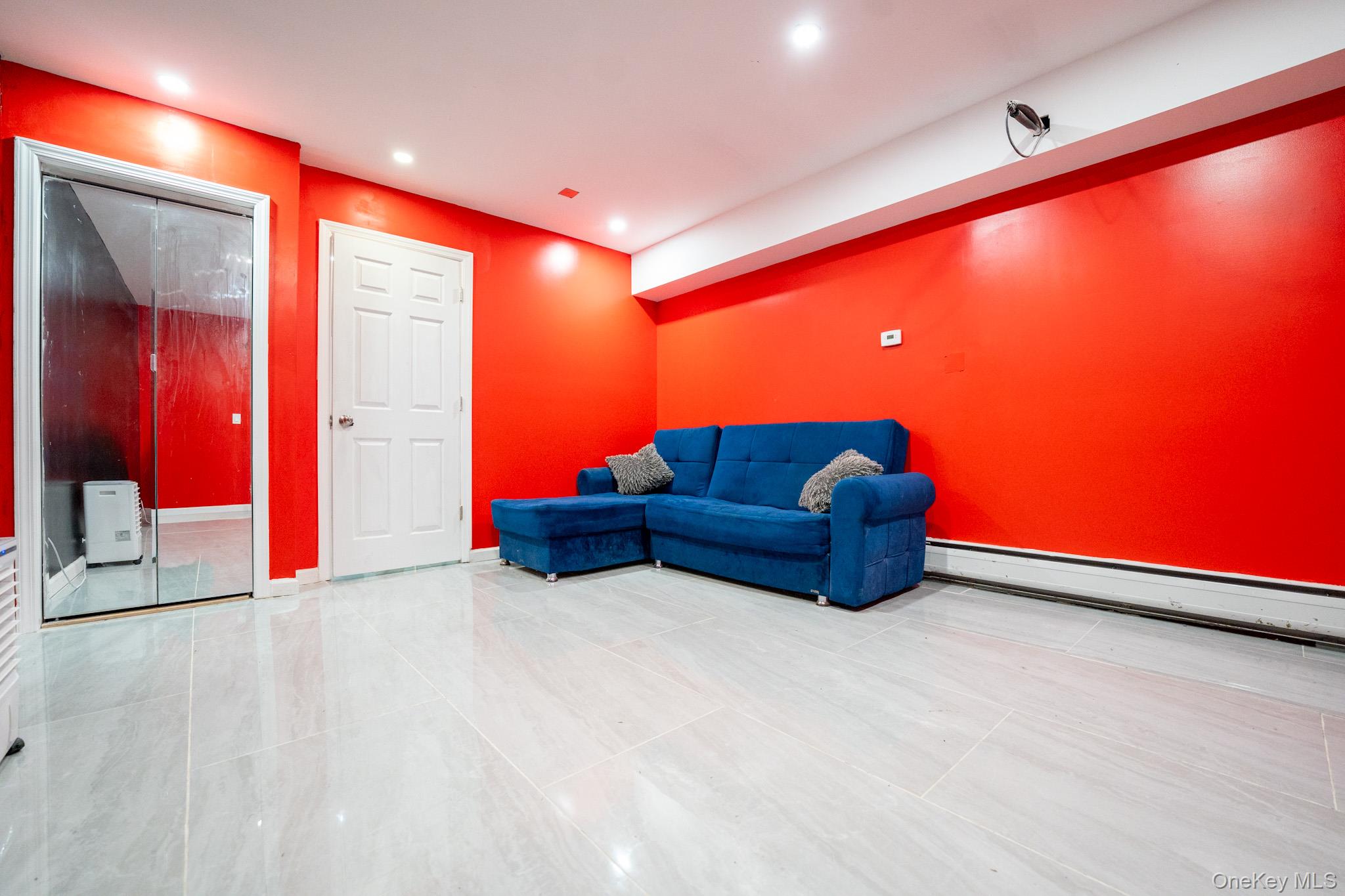 23 Yucca Drive Staten Island, NY 10312 - Photo 12 of 21 Living area with a baseboard heating unit and recessed lighting