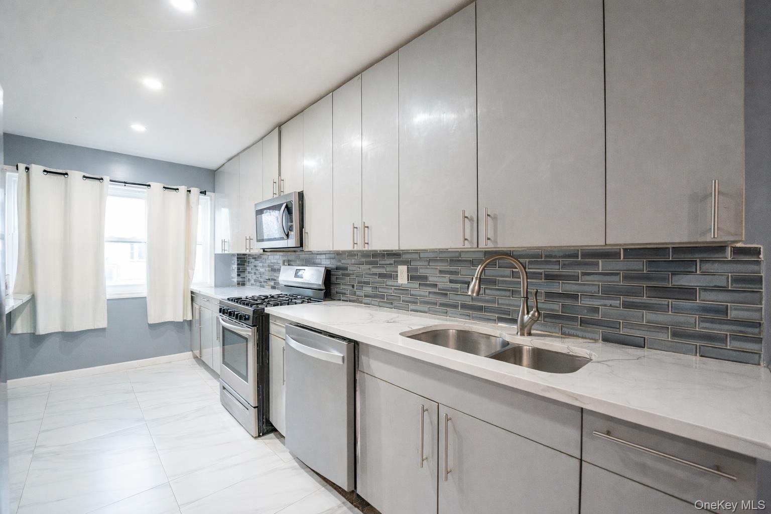 23 Yucca Drive Staten Island, NY 10312 - Photo 16 of 21 Kitchen with stainless steel appliances, light stone counters, recessed lighting, and backsplash