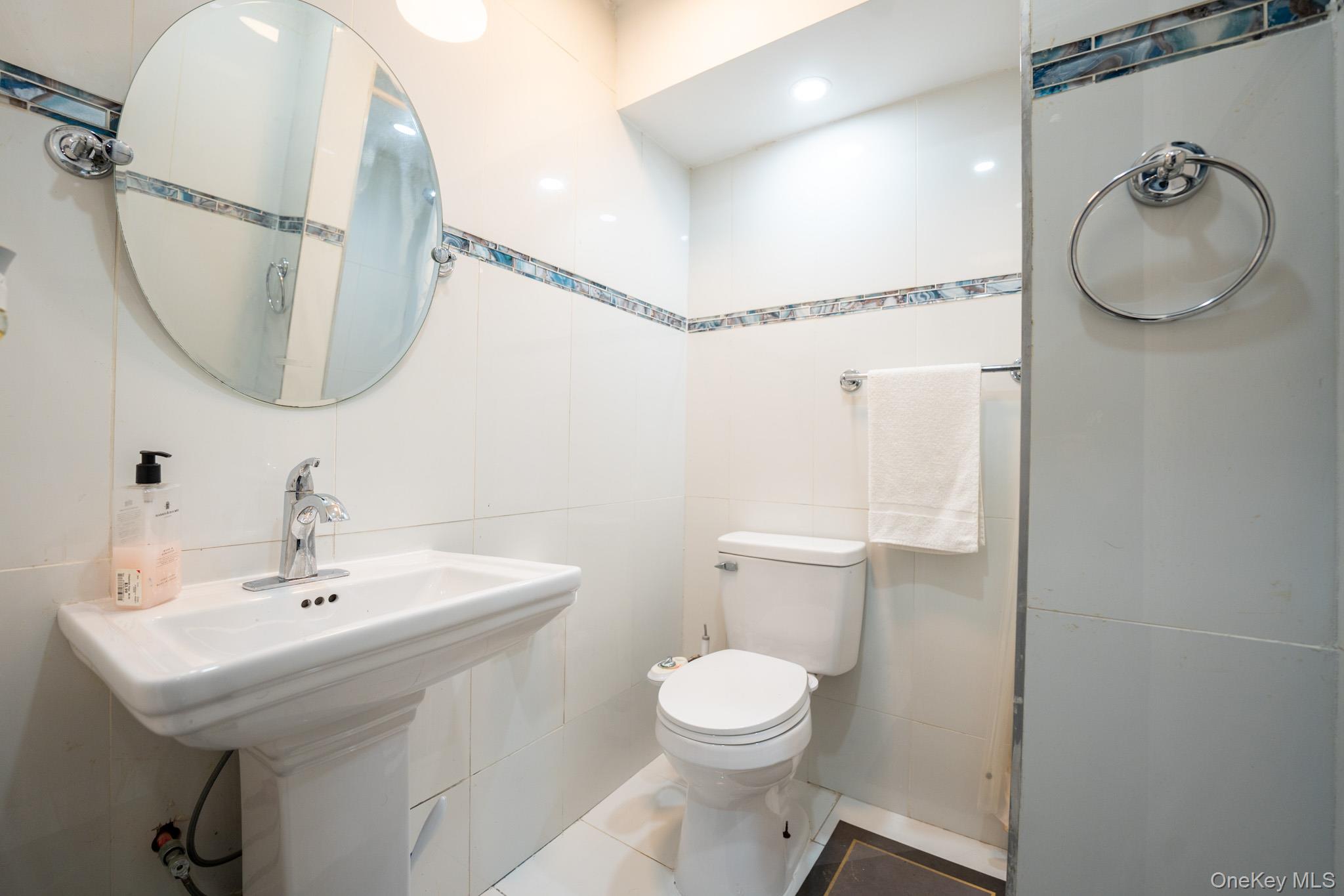 23 Yucca Drive Staten Island, NY 10312 - Photo 19 of 21 Half bathroom featuring tile walls and tile patterned flooring