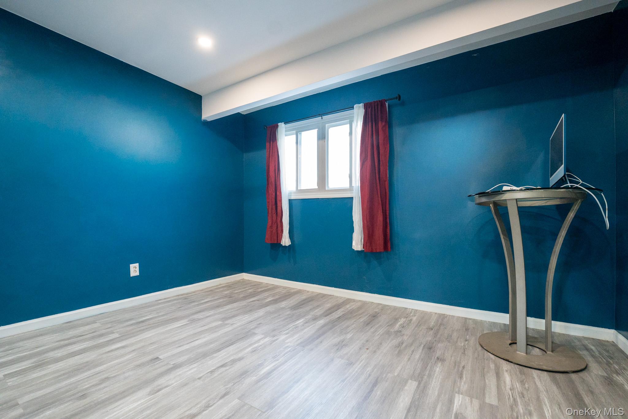 23 Yucca Drive Staten Island, NY 10312 - Photo 7 of 21 Unfurnished room with baseboards and wood finished floors