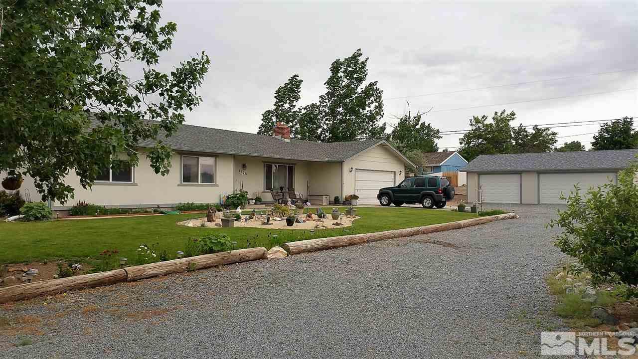 10675 Santa Fe Road Reno, NV 89508 - Photo 1 of 1 a front view of a house with a yard and garage