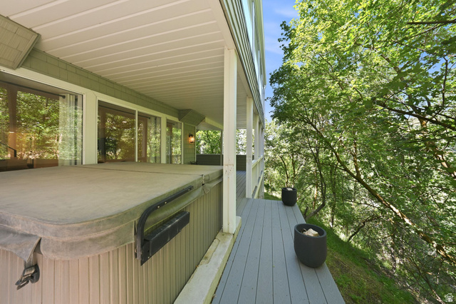 1979 Cave Hollow Way Bountiful, UT 84010 - Photo 41 of 59 Covered outdoor deck with a hot tub and wood-finish decking