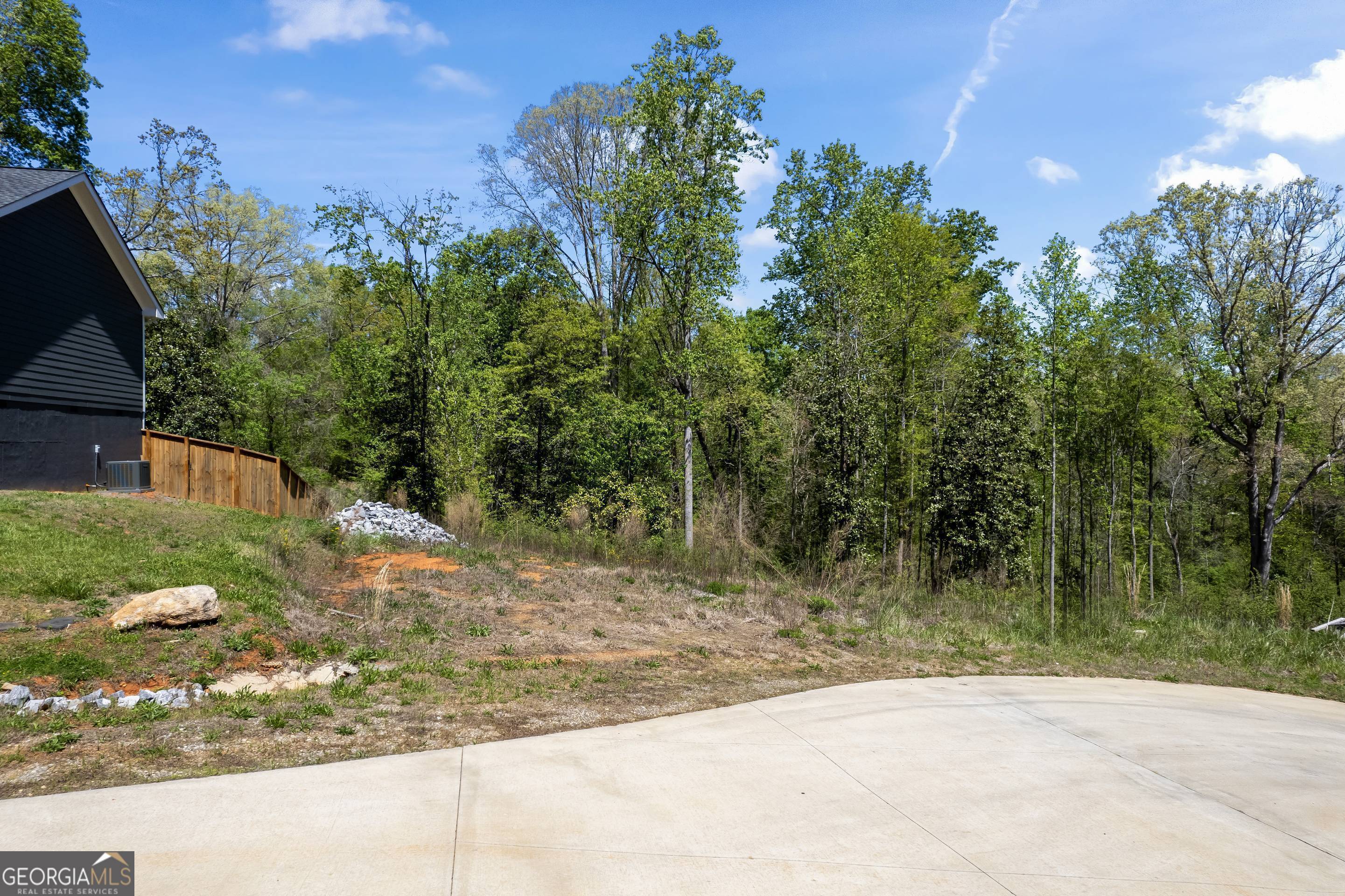 253 Lacount Lane Clarkesville, GA 30523 - Photo 17 of 18 a view of a yard with plants and a bench