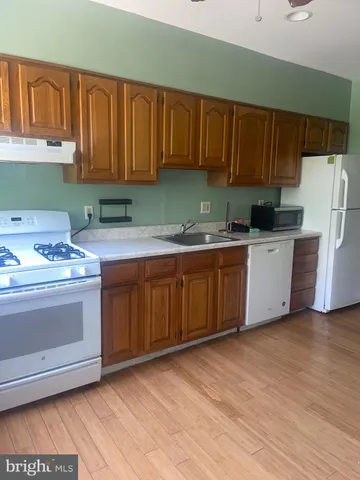 a kitchen with a cabinets and wooden floor