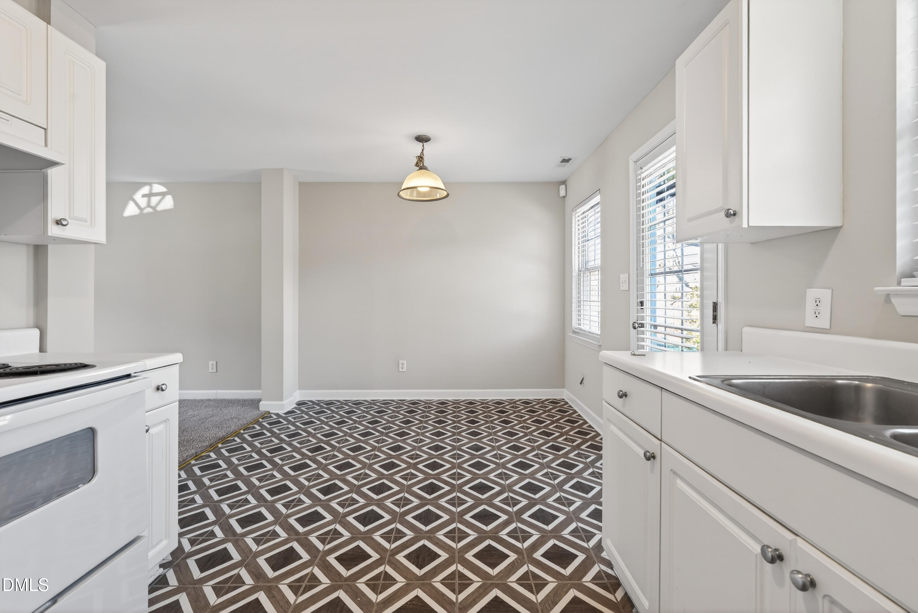 1601 Briarmont Court Raleigh, NC 27610 - Photo 18 of 30 a kitchen with a sink and a stove